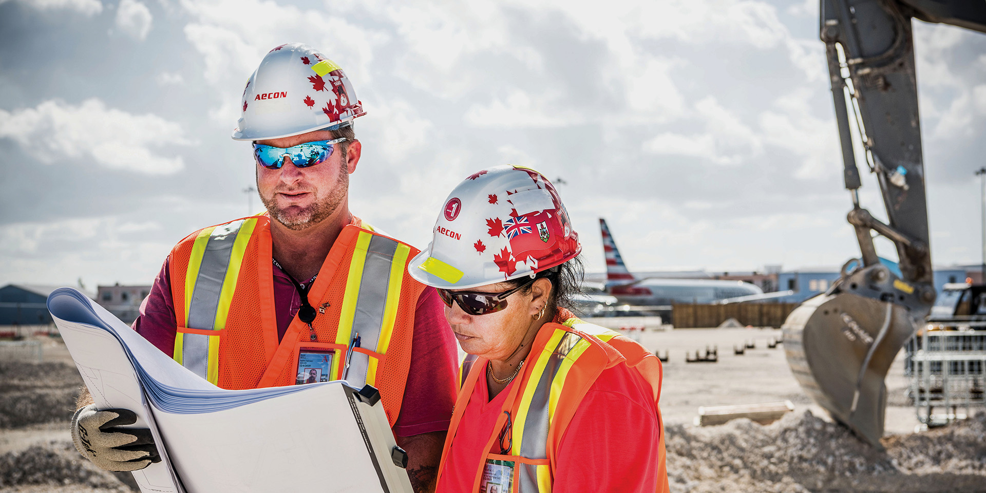 Two Aecon workers looking at documents on site