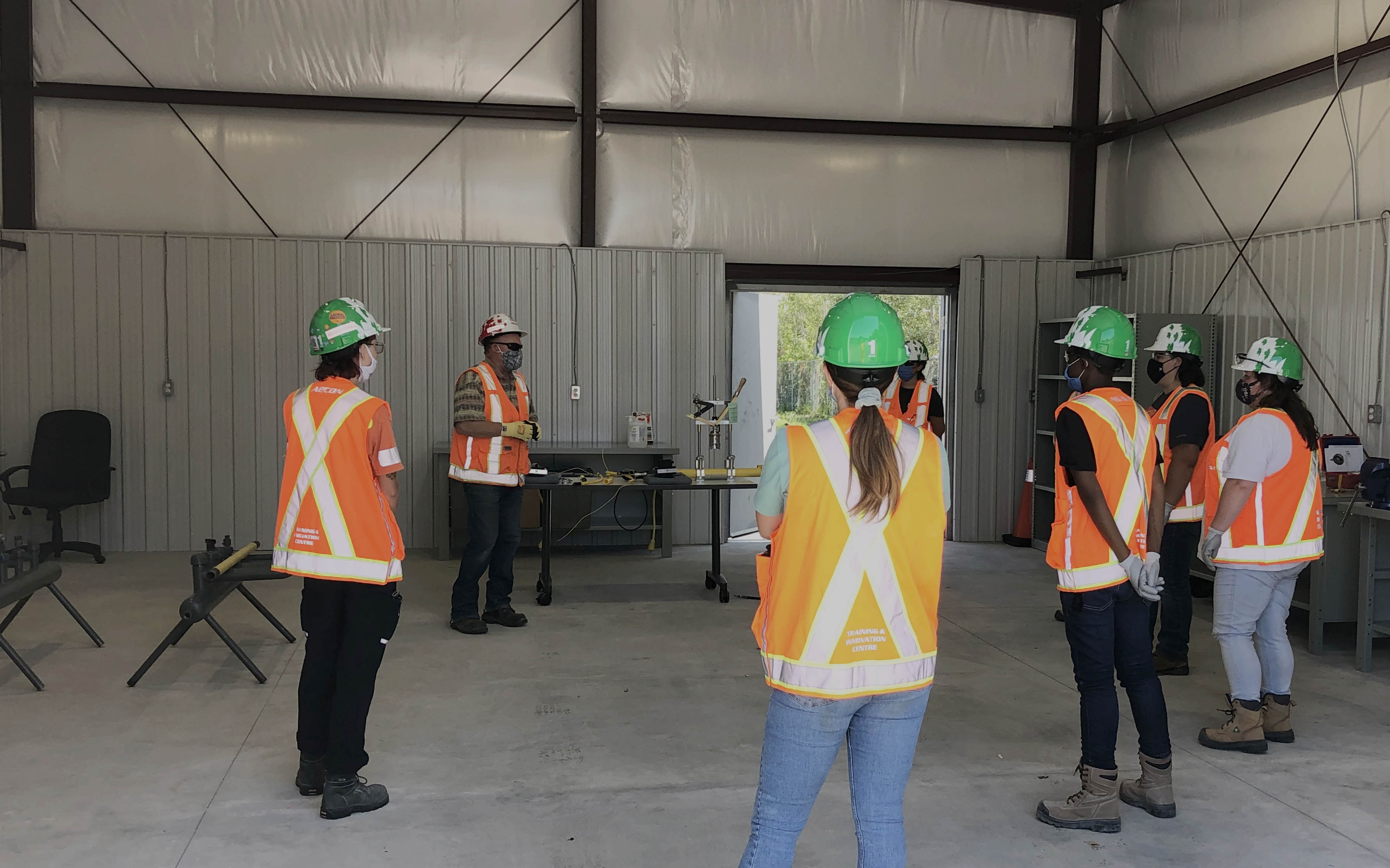 Aecon staff wearing safety gear and PPE on a site